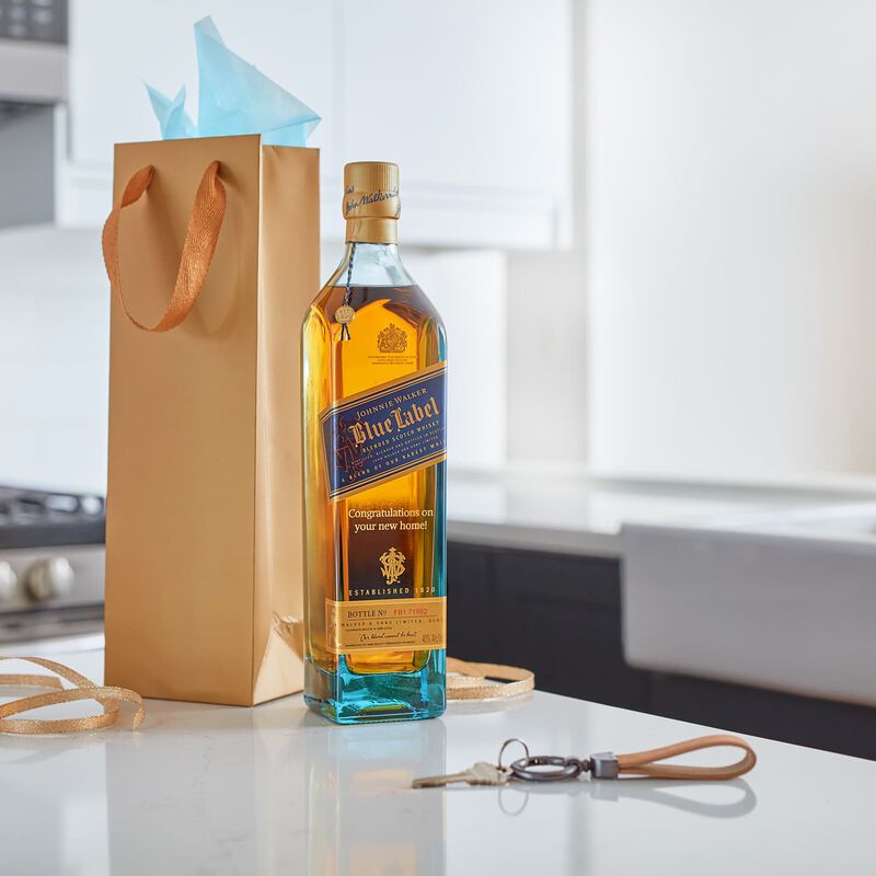 A custom engraved bottle of Johnnie Walker Blue greets new homeowners